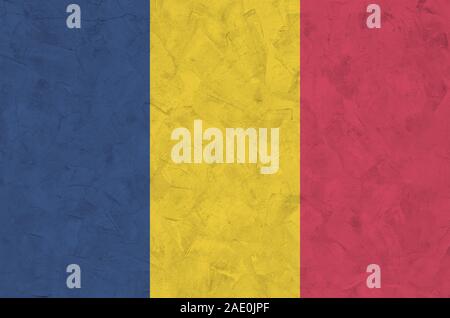 Chad flag depicted in bright paint colors on old relief plastering wall close up. Textured banner on rough background Stock Photo