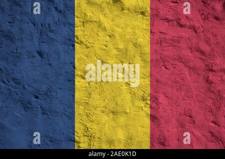 Chad flag depicted in bright paint colors on old relief plastering wall close up. Textured banner on rough background Stock Photo