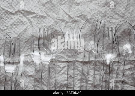 The plastic spoons and forks on crumpled floor Stock Photo