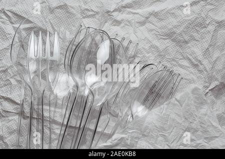 The plastic spoons and forks on crumpled floor Stock Photo