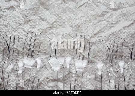 The plastic spoons and forks on crumpled floor Stock Photo