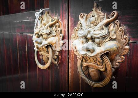 chinese style red door with lion head doorknob and copper ball Stock Photo