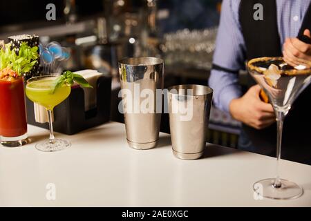 cropped view of barman preparing cocktails in bar Stock Photo