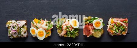 panoramic shot of tasty danish smorrebrod sandwiches on grey  surface Stock Photo