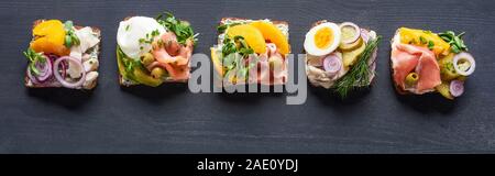 panoramic shot of delicious danish smorrebrod sandwiches on grey Stock Photo