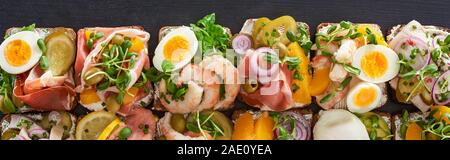 panoramic shot of traditional smorrebrod sandwiches with boiled eggs on grey surface Stock Photo