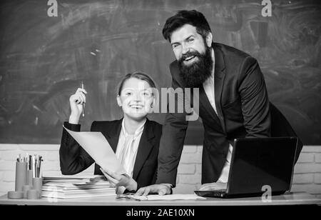 Look at this. teacher and student on exam. businessman and secretary. back to school. Non-formal education. paper work. office life. business couple use laptop and documents. Living in digital age. Stock Photo