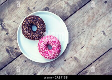 A plate of delicious donuts on a table. Stock Photo