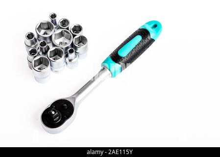Crafts and repair. Knob for socket wrench nut ratchet close up. Ratchet tool. Ratchet wrench. Steel made no skid threaded handle without slipping. Universal socket set white background isolated. Stock Photo