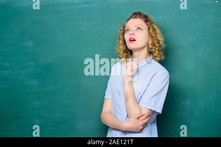 Teacher best friend of learners. Good teacher is master of simplification. Passionate about knowledge. Teaching could be more fun. Woman teacher in front of chalkboard. Teacher explain hard topic. Stock Photo