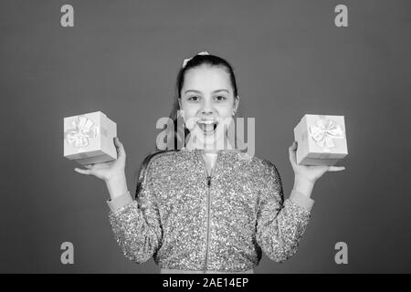 Black friday. Shopping day. Cute child carry gift boxes. Surprise gift box. Birthday wish list. World of happiness. Pick bonus. Special happens every day. Girl with gift boxes blue background. Stock Photo