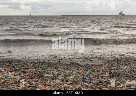 Manila, Philippines - August 23, 2017: Plastic waste in a pile of garbage in the sea shore Stock Photo