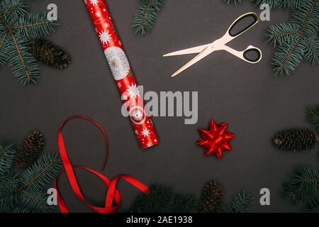 top view of green wrapping paper, scissors and present with red ribbon on  wooden background Stock Photo by LightFieldStudios