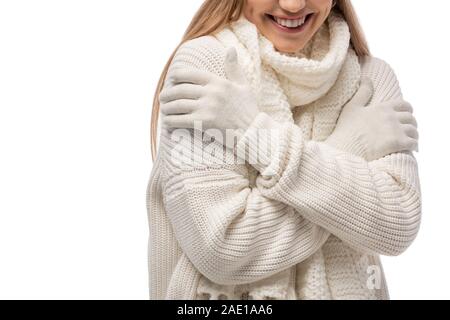 cropped view of smiling woman warming up in white knitted clothes, isolated on white Stock Photo