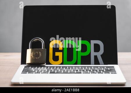 metal padlock and gdpr letters on laptop in office Stock Photo