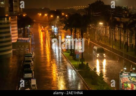 The rain was heavy on city streets at night , Muang Thong Thani , Nonthaburi in Thailand. 20 October 2018. Stock Photo