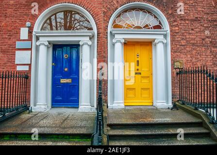 Two vintage Georgian doors in yellow and blue in Dublin Stock Photo