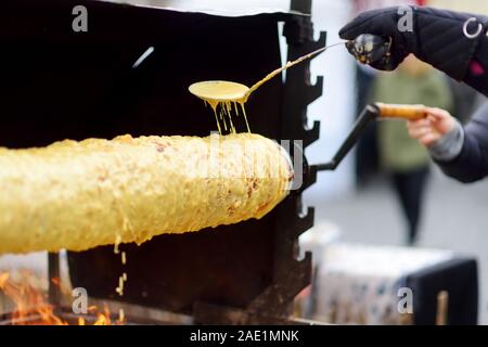 Traditional Lithuanian tree cake called 'sakotis' baked at annual Easter fair in Vilnius, Lithuania Stock Photo