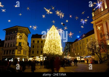 Night time Christmas Illumination with tree and hanging star in main Square. Ljubljana, Slovenia. Stock Photo