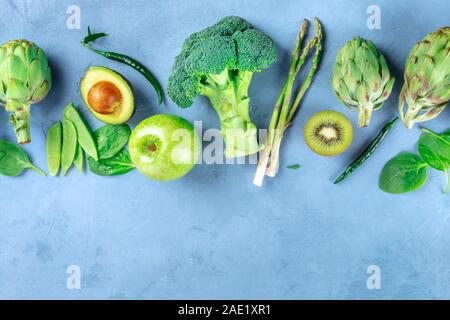 Green food, fruits and vegetables, detox diet ingredients, shot from the top with a place for text. Broccoli, asparagus, avocado, artichokes etc Stock Photo