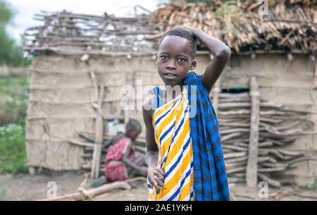 Same, Tanzania, 7th June 2019: maasai kid with a goat Stock Photo