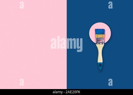 Renovation concept. Pink and classic blue background with paint brush and can on a pink circle. Flat lay, top view, copy space. Stock Photo