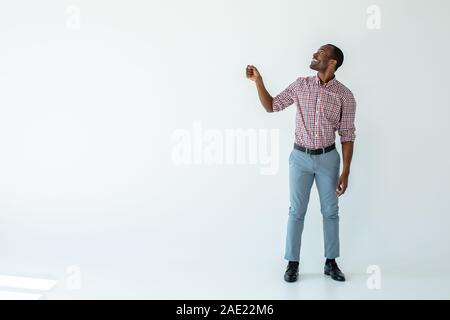 Joyful afro american man holding an umbrella Stock Photo