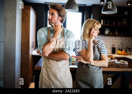 Unhappy couple having argument and fight in kitchen that leads to divorce Stock Photo