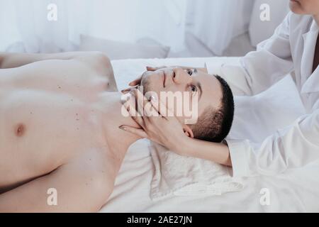 male masseuse makes a therapeutic massage spa Stock Photo