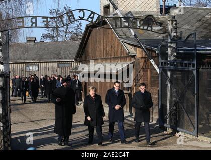 Oswiecim, Poland. 6th Dec, 2019. Angela Merkel and Mateusz Morawiecki at the entrance of Auschwitz. Politicians walks trough the gate of the Nazi concentration camp bearing the motto Arbeit macht frei. German Chancellor Angela Merkel and prime minister of Poland Mateusz Morawiecki visit the former Nazi death camp of Auschwitz. Credit: Damian Klamka/ZUMA Wire/Alamy Live News Stock Photo