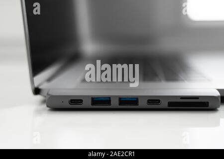 The USB adapter under the Type-C connector for laptop. Multiport station for laptop with multiple different ports. USB to USB Type-C Hub Converter Stock Photo