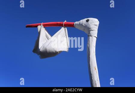 Buching, Germany. 06th Dec, 2019. A homemade stork figure with a bag in its beak symbolizes the birth of a baby in front of a farm. Credit: Karl-Josef Hildenbrand/dpa/Alamy Live News Stock Photo