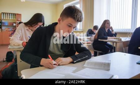 Schoolchild in class busy with work. Russian school. Stock Photo