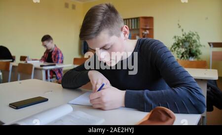 Schoolchild in class busy with work. Russian school. Stock Photo
