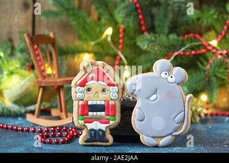 Homemade christmas gingerbreads painted as a mouse and Nutcracker on the white background with fir branches. Selective focus and place for text. Stock Photo