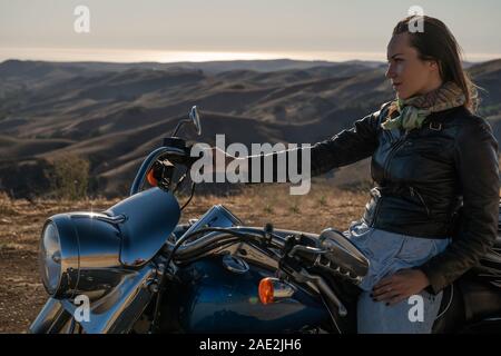 Woman biker sitting on her motorcycle Stock Photo