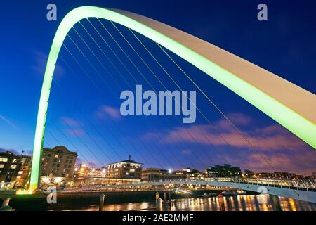 Architectural detail of the arch of the Gateshead Millennium Bridge illuminated at dusk Stock Photo