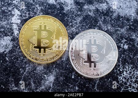 White and yellow bitcoins. E-commerce concept. Blockchain, international mining. Cryptocurrency on dark background. Stock Photo