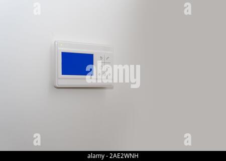 video intercom on a white wall near the entrance door to the apartment. Stock Photo