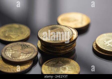Stack of golden Dash bitcoin coin with a lot of bitcoins coins on a table. Virtual cryptocurrency concept. Mining of bitcoins online bussiness Stock Photo