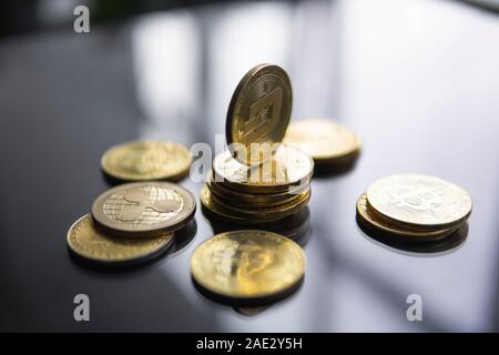 Stack of golden Dash bitcoin coin with a lot of bitcoins coins on a table. Virtual cryptocurrency concept. Mining of bitcoins online bussiness Stock Photo
