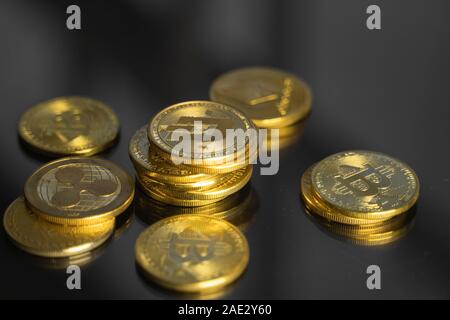 Stack of golden Dash bitcoin coin with a lot of bitcoins coins on a table. Virtual cryptocurrency concept. Mining of bitcoins online bussiness Stock Photo