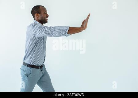 Positive man moving the block Stock Photo