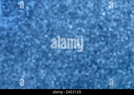 Defocused background with glitter in modern trendy blue color. Bokeh effect. Stock Photo