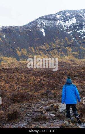 Man walking at Black Cuillin and Fairy Pools, river Brittle, Isle of Skye, Scotland, UK in March Stock Photo