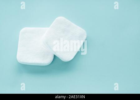 Cosmetology, cleanliness and branding concept - Organic cotton pads on mint background, cosmetics and make-up remover, hygiene and skincare beauty bra Stock Photo
