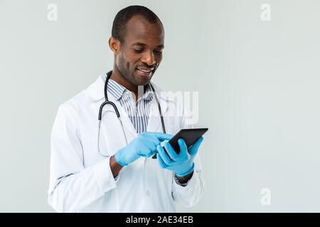 Positive doctor using his tablet Stock Photo