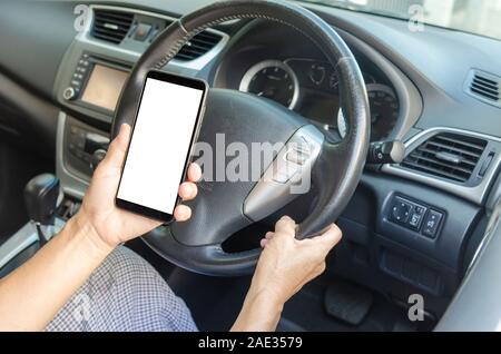 Women's hand holding a mobile phone in the car Stock Photo
