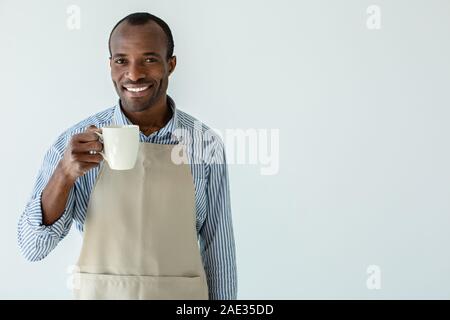 Positive cafe owner drinking coffee Stock Photo