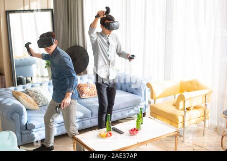 Young friends playing VR game Stock Photo